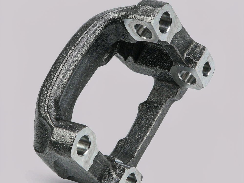 Curved ductile iron caliper bracket with two machined through bores