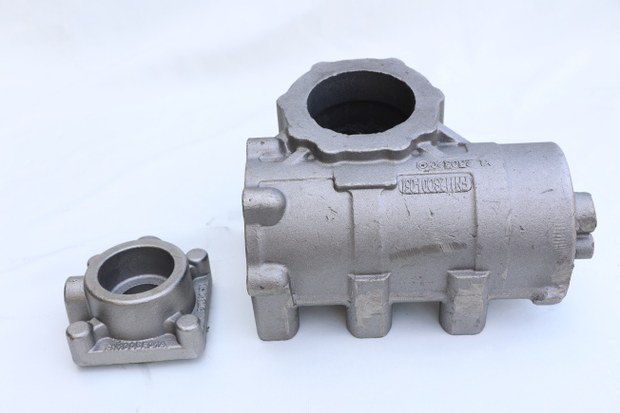 Flanged cylindrical housing with a small cover casting beside it